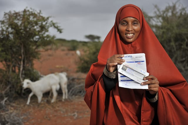 Woman holding a livestock insurance policy