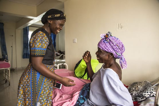 Fistula Foundation worker laughing with patient in Kenya