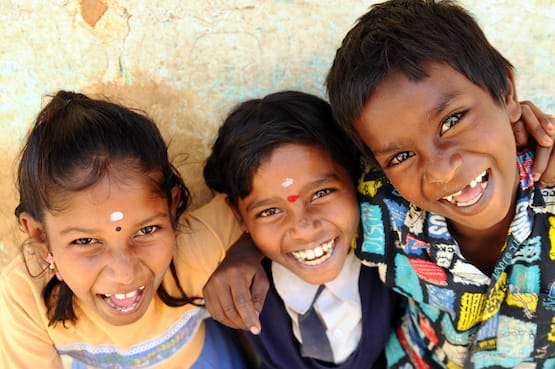 Three kids grinning in Bangalore