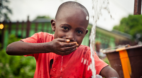 Boy drinking water from tap