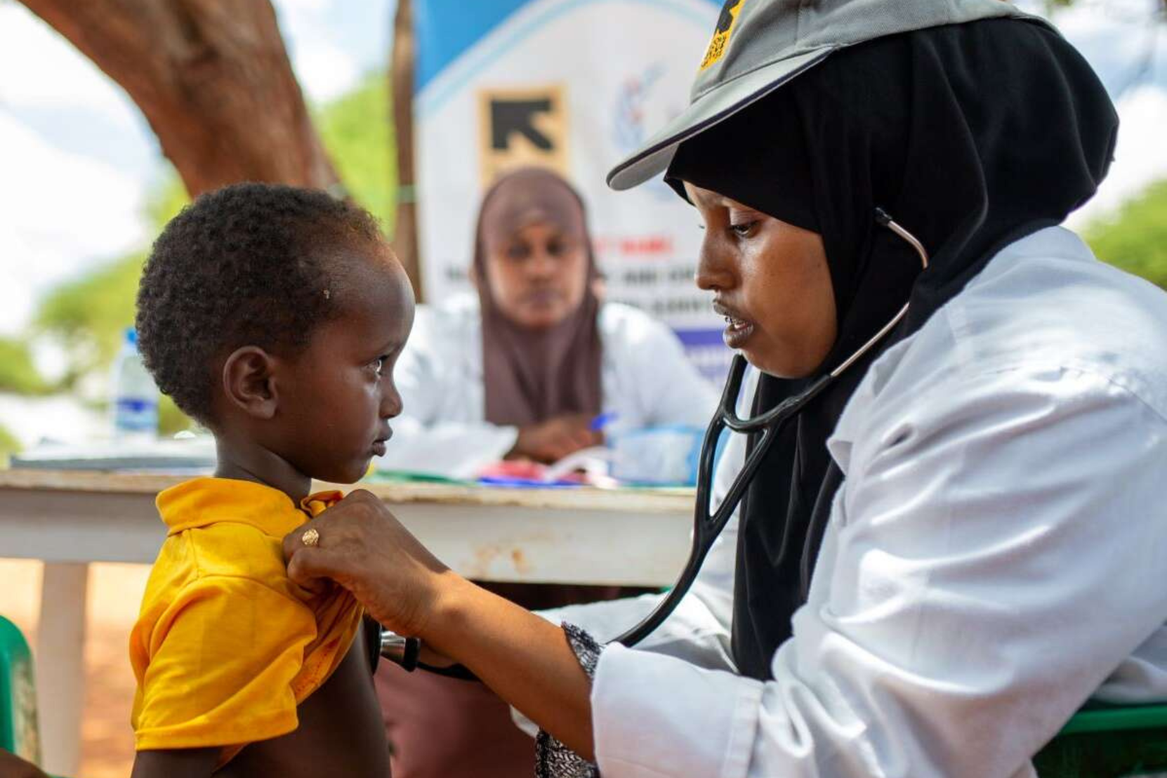 International Rescue Committee, a doctor examining a young child