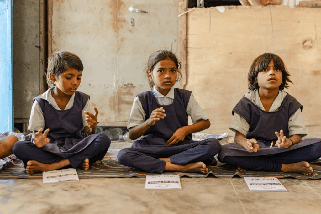 Educate girls. Girls sitting down in a classroom. Giving Season